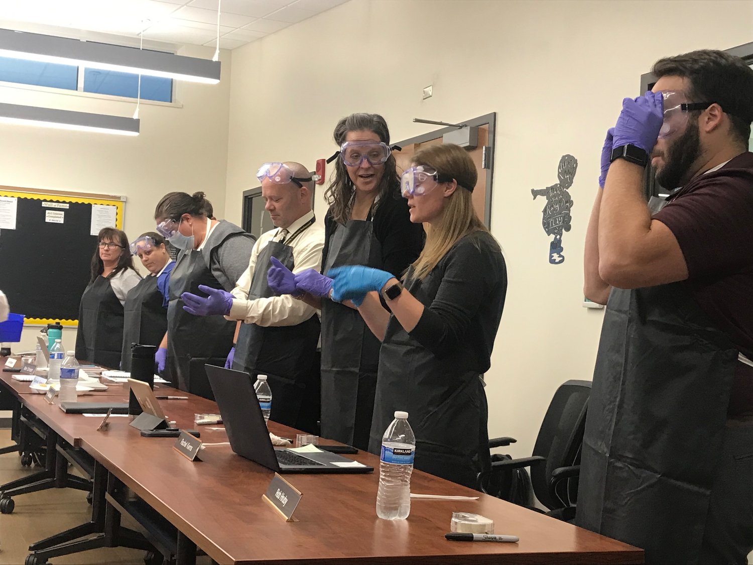 School board members and administrators don their PPE to participate in a Scale Up Award activity.